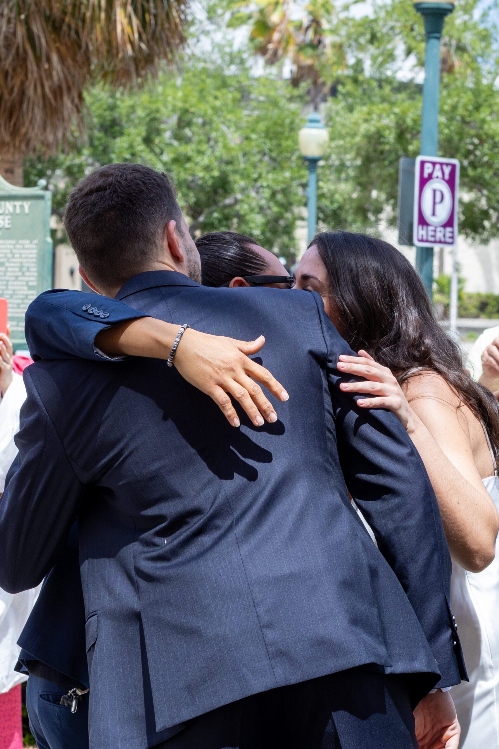 couple hugging others during their sarasota elopement day
