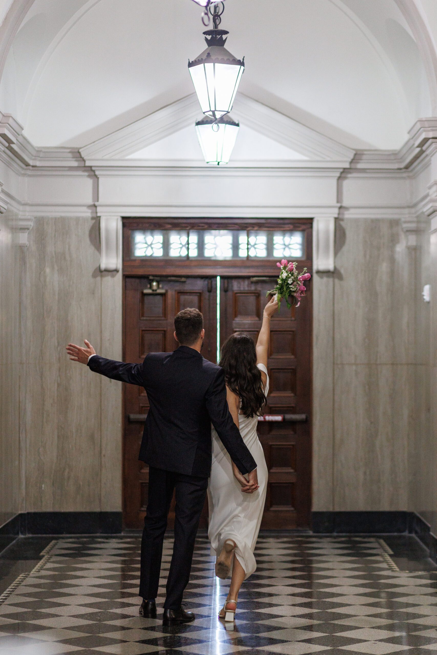 Couple walking down the sarasota courthouse hallway during their elopement