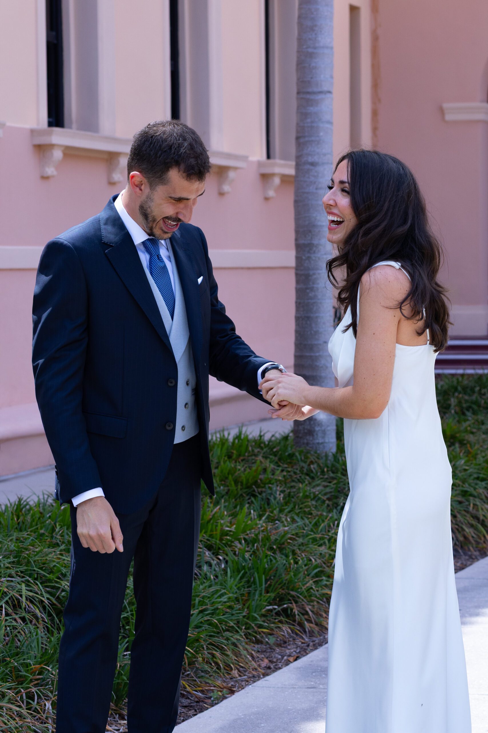 Couple holding hands outside a courthouse before their Florida elopement ceremony.